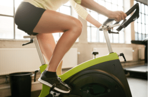fitness woman working out on exercise bike at the gym.