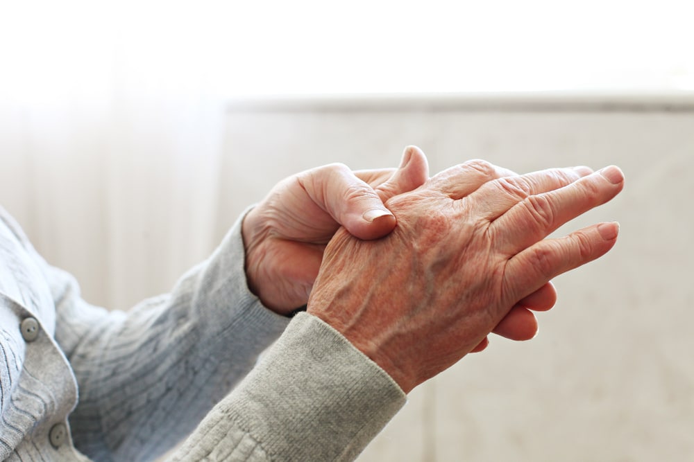 Close up of elderly woman’s hands with hand veins.