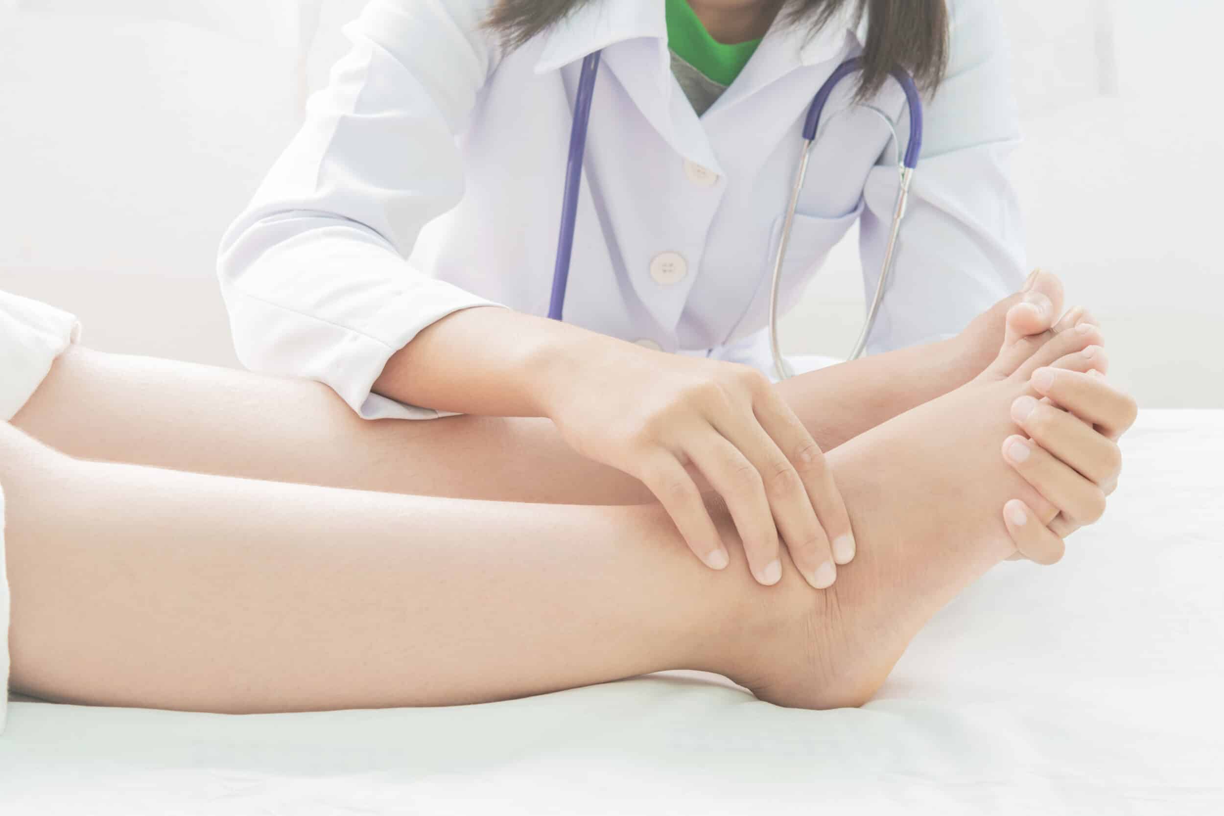 Doctor examining a patient's leg with symptoms of chronic leg ulcer in Los Angeles