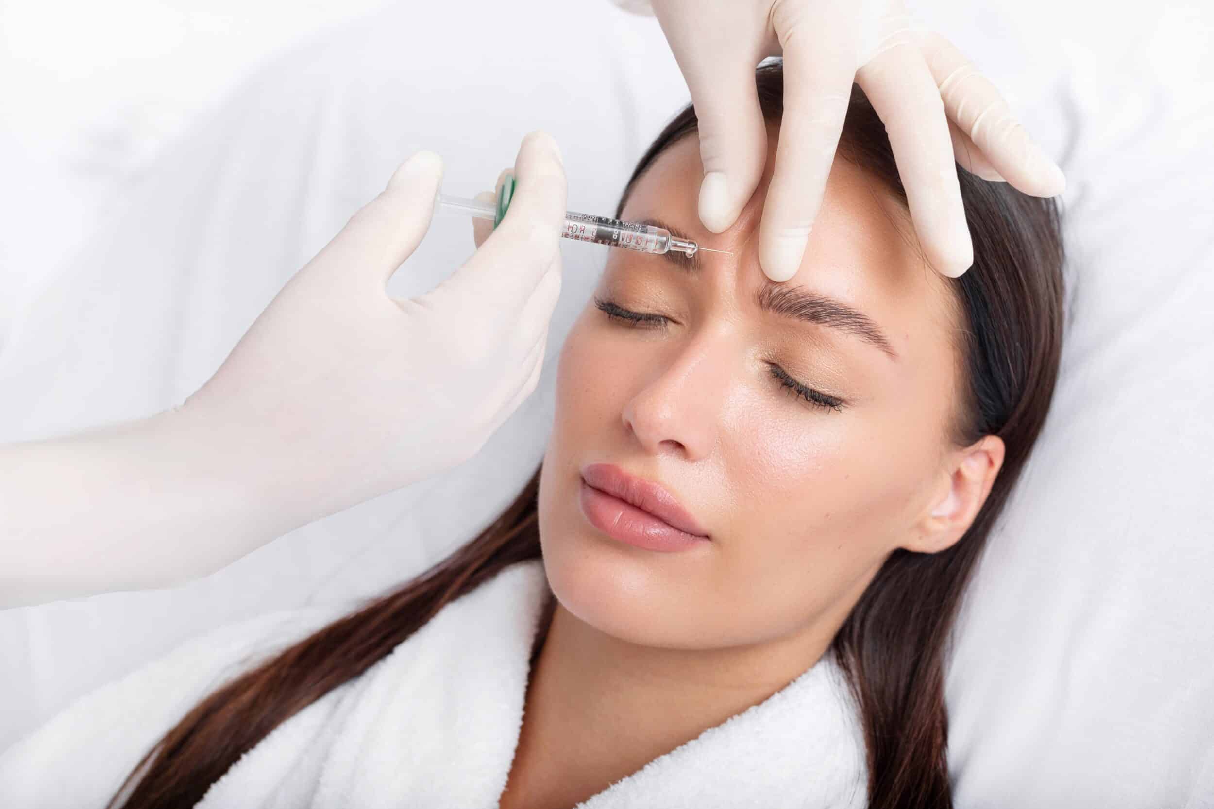 Relaxed woman getting Xeomin Injections in her forehead in Los Angeles